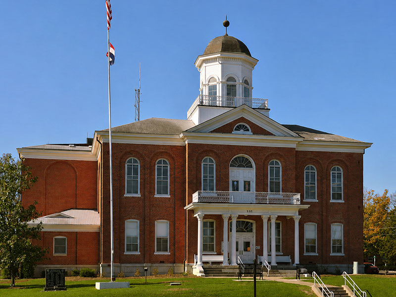 Historic courthouse in Lincoln County, Missouri, featuring red brick architecture, a dome, and flagpole, representing